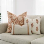 Elle cushions styled on sofa with burgundy, cream and soft textured designs.