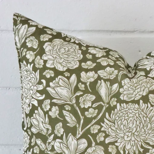 A sideways perspective of this linen cushion. The positioning shows the border of the 45x45 shape and the olive green colour.