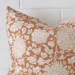 A detailed shot of this terracotta floral cushion cover that has linen fabric and a 45x45 size.