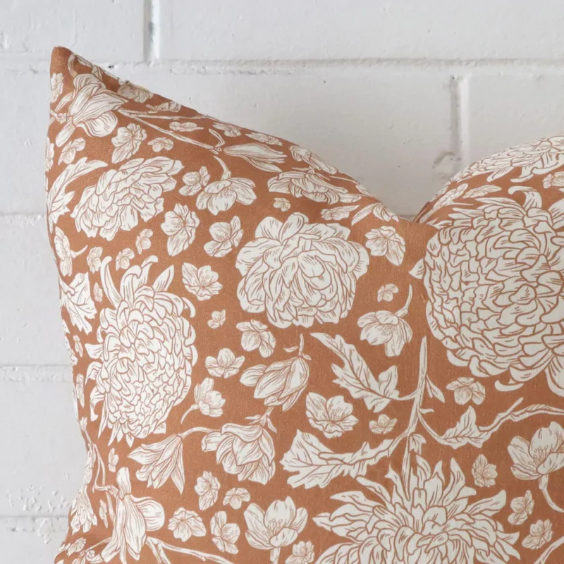 A detailed shot of this terracotta floral cushion cover that has linen fabric and a 45x45 size.