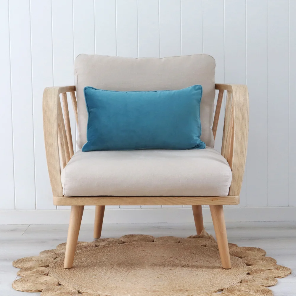 An aqua cushion placed in the middle of a wooden chair.