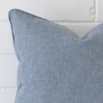 A detailed shot of this blue cushion cover that has linen fabric and a square size.