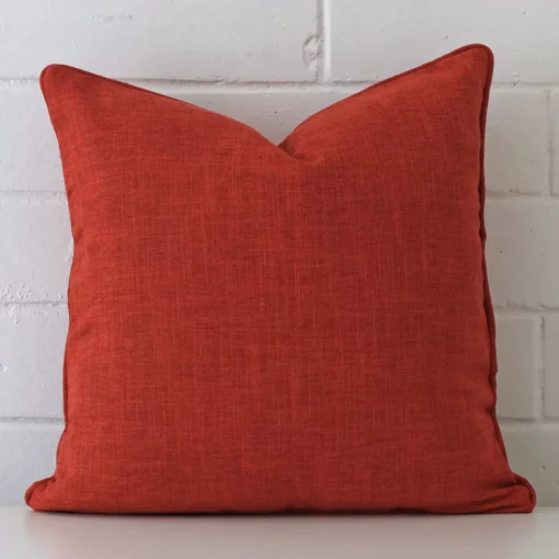Front view of square cushion. Crafted from a special linen material in a burnt orange colour.