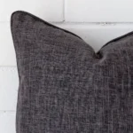 The corner of this linen square cushion cover is shown close up. The grey colour is shown in greater detail.
