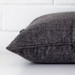 Side angle shot of linen square cushion cover. The grey hue is shown with more clarity.