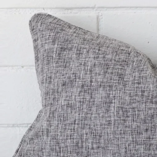 Zoomed in visual of rectangle cushion cover in grey.