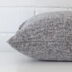 Side perspective showing seam of square grey cushion cover that is made from a linen fabric.