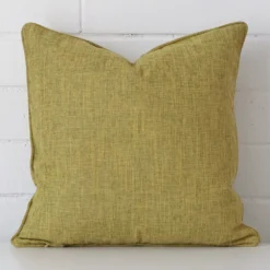 An eye-catching linen square cushion cover featuring a hue that is olive.