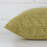 Lateral view of front and back panels of this linen cushion cover in a square size and with olive colouring.