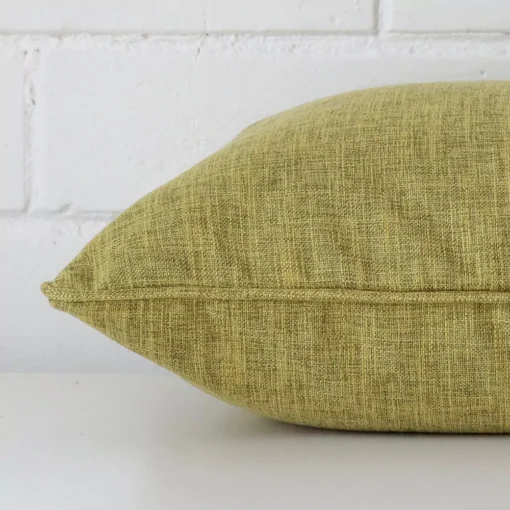 Lateral view of front and back panels of this linen cushion cover in a square size and with olive colouring.