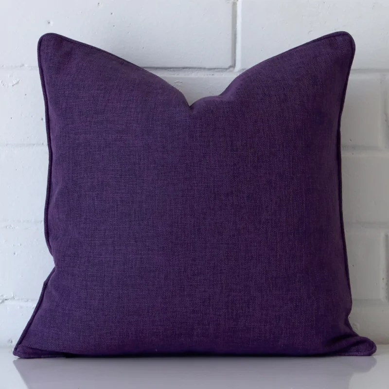 arlington-plum-purple-cushion-cover-45cm-x-45cm-sc455-45 An attractive linen cushion in front of a white brick wall. It has a square shape and is plum in colour.
