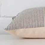 Lateral viewpoint of this designer rectangle cushion. The striped design is shown from the side showing the front and rear panels.