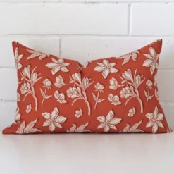 A premium linen rust cushion boasting a floral design and in a rectangle size.