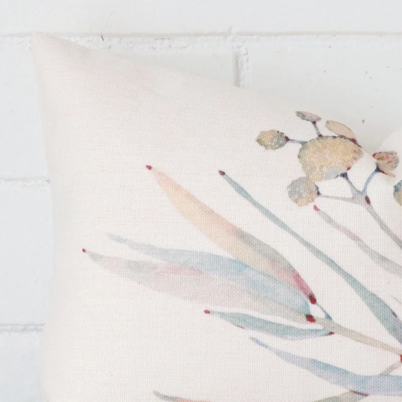 Cropped shot of top left corner of this cushion cover. This viewpoint shows the linen fabric and rectangle shape with more precision.