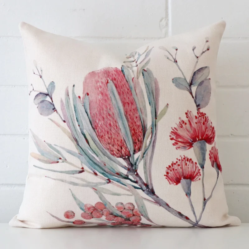 australian-botanicals-pink-posy-cushion-cover-45cm-x-45cm-sc822-45 Linen cushion cover features prominently against a white wall. It is a square design and has a floral decorative finish.