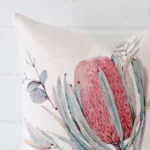 Focused view of floral square cushion cover. The shot shows details of its linen material.