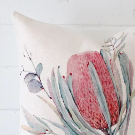 Focused view of floral square cushion cover. The shot shows details of its linen material.