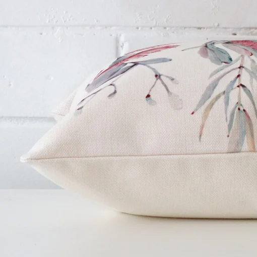 Square floral cushion cover sitting flat. The sideways viewpoint shows the seams of the linen material.