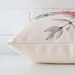 Floral cushion cover laid on its back side. The image shows a side-on view of the linen material and its square dimensions.