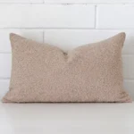 Gorgeous rectangle boucle cushion cover that has a beige hue.
