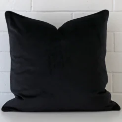 An eye-catching velvet square cushion cover featuring a hue that is black.
