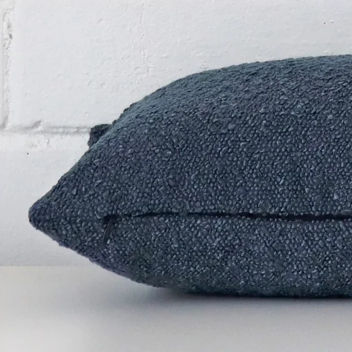 Boucle blue cushion laying on its side. The rectangle size is visible