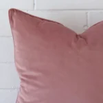 Close up image of velvet square cushion. The image allows you to see the blush hue more thoroughly.