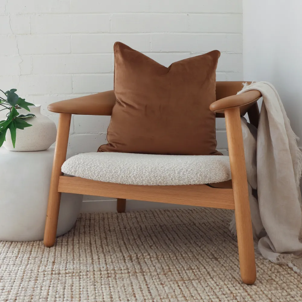 A brown cushion sits on a chair in a corner scene.