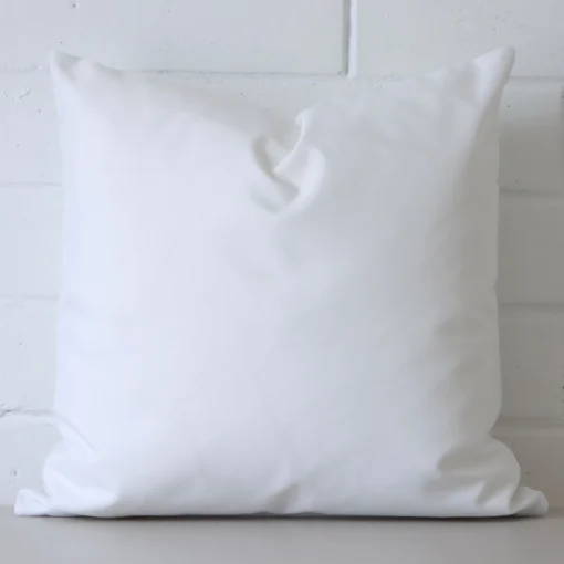 A gorgeous outdoor square cushion in white.