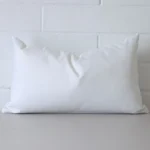 Striking rectangle white cushion cover featuring an outdoor fabric.