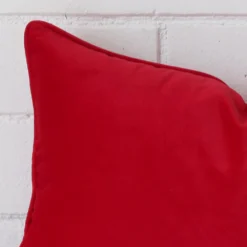 Zoomed in visual of velvet rectangle cushion cover in red.