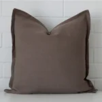 Chocolate Brown linen cushion cover features prominently against a white wall. It is a square design.