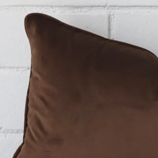 Corner section image showing features of rectangle velvet cushion that has velvet fabric.
