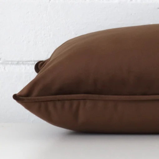 Side edge of rectangle cushion. The velvet material and chocolate colour can be seen from this lateral viewpoint.