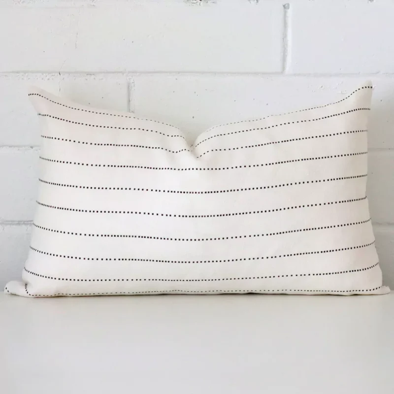clara-linen-striped-cushion-cover-rectangle-sc1001-30 An attractive striped linen cushion in front of a white brick wall. It has a rectangle shape.