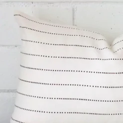 Macro shot showing the top left side of this rectangle linen cushion. The striped design is magnified.