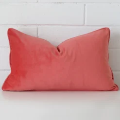 A premium velvet coral cushion in a rectangle size.