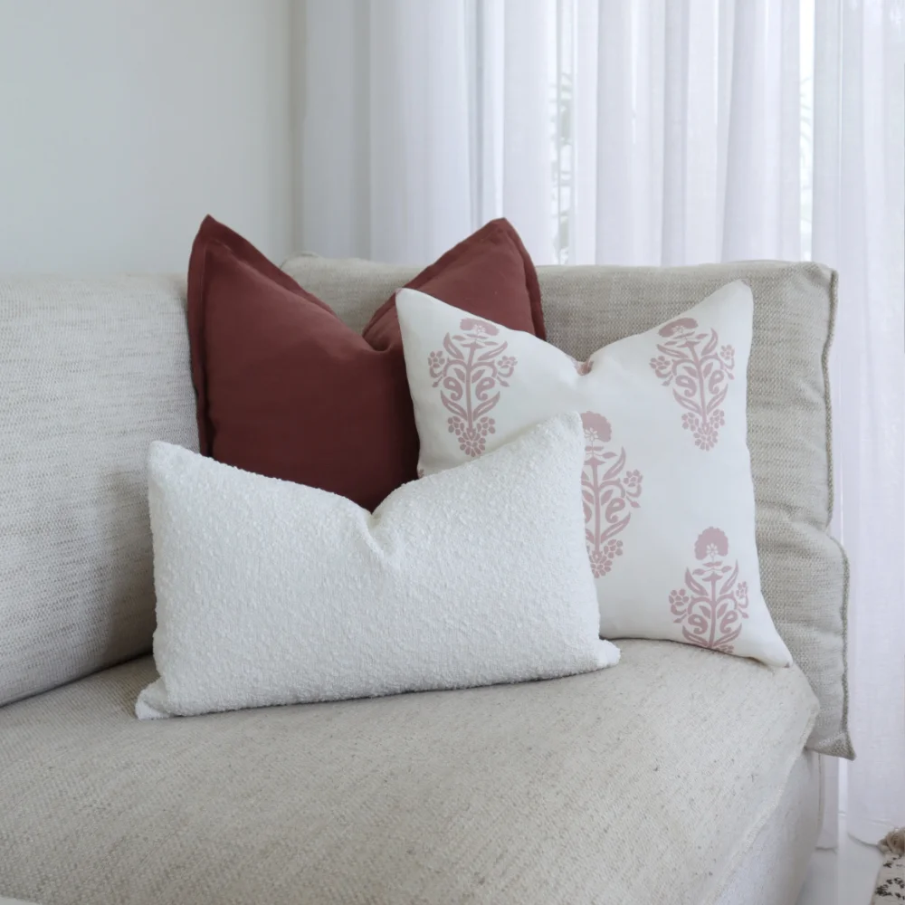 Three couch cushions are arranged in the corner of a seat.