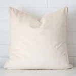 Striking square cream cushion cover featuring a velvet fabric.