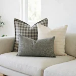 Darcy cushions on sofa with check pattern, soft cream and muted floral design.