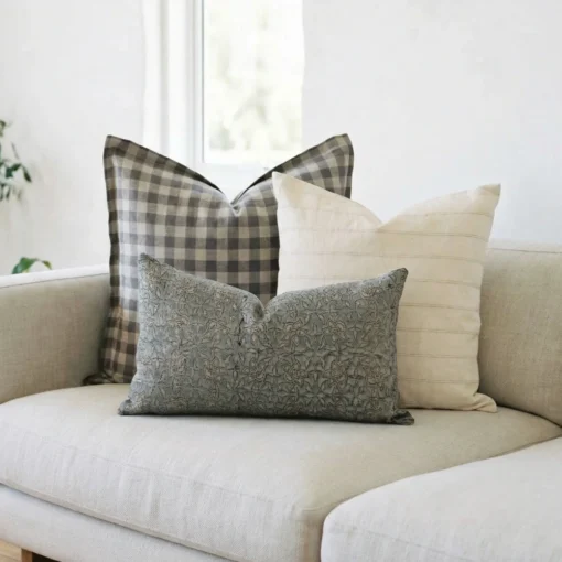 Darcy cushions on sofa with check pattern, soft cream and muted floral design.