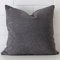 Striking square dark grey cushion cover featuring a quality boucle fabric.