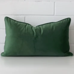 Front view of rectangle cushion. Crafted from a special velvet material in a dark sage colour.