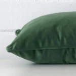 Close side shot of this dark sage velvet cushion cover. It has a rectangle design.