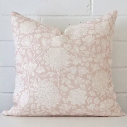An eye-catching linen square cushion cover featuring a hue that is light pink. It has a unique floral style.