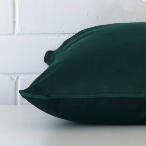 Close side shot of this emerald green velvet cushion cover.
