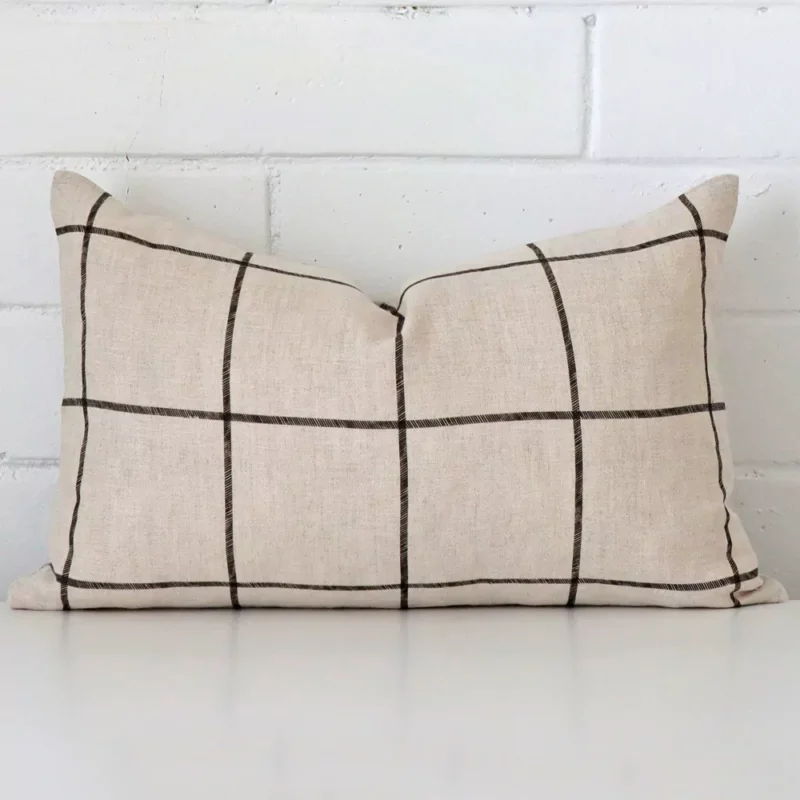 emma-linen-check-cushion-cover-rectangle-sc1002-30 rectangle check cushion sitting upright in front of a brick wall. It has been made from a quality linen material.
