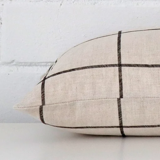 Check cushion cover laid on its back side. The image shows a side-on view of the linen material and its rectangle dimensions.