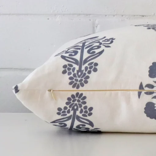 A side view of light blue patterned cushion that has linen fabric and a square size.
