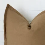 Close up image of linen square cushion. The image allows you to see the fawn hue more thoroughly.